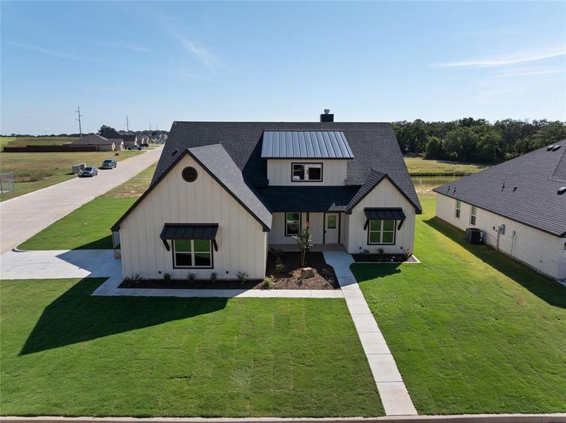 Front view of home: fully landscaped with a large front yard complete with an irrigation system