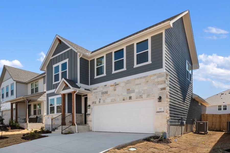Front exterior of a new home in Cannon Ranch, Dripping Springs, TX, highlighting curb appeal (Image 23).