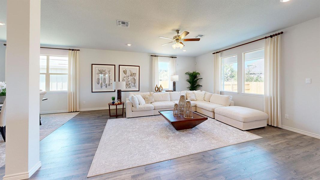 Living area featuring a ceiling fan, hardwood / wood-style flooring, and recessed lighting Living area featuring a ceiling fan, hardwood / wood-style flooring, and recessed lighting