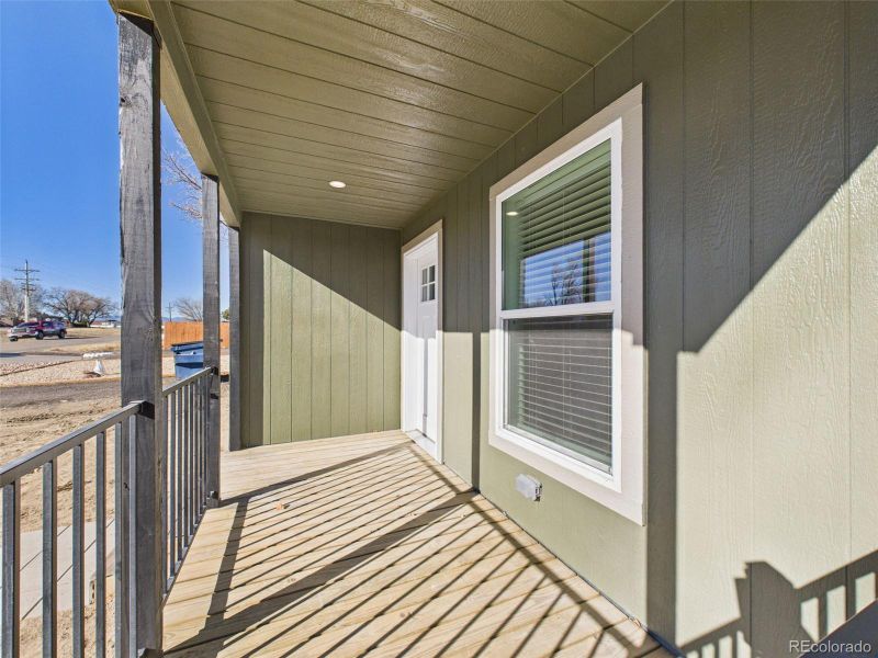 Front Porch (Unstaged) – Covered and elevated, the front entry features clean lines and a welcoming view over the front yard and street.