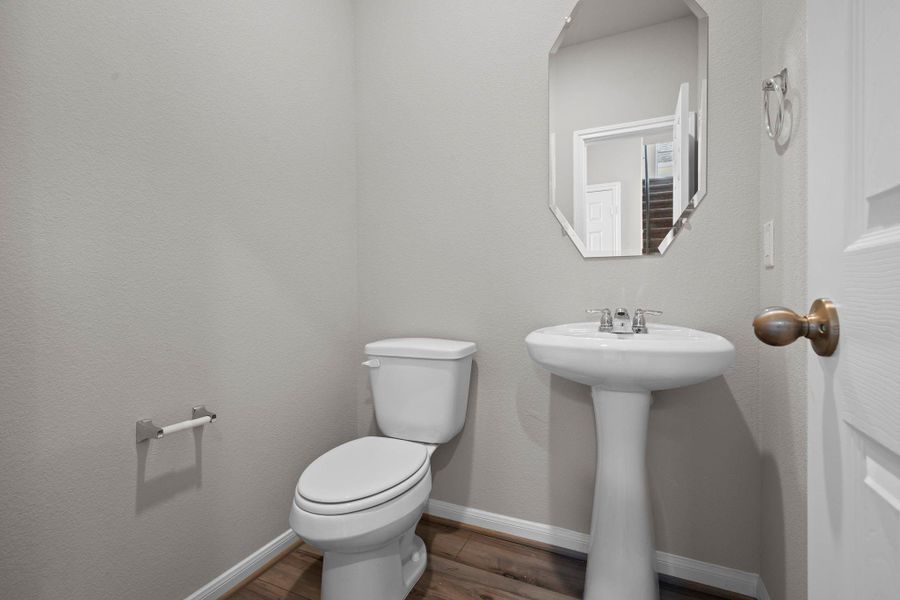 This charming home features a beautifully appointed half bath adjacent to the family room, perfect for welcoming guests and adding convenience to your daily life.