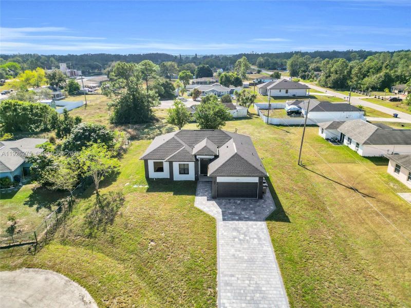 Front exterior of a new home in , Lehigh Acres, FL, highlighting curb appeal (Image 20).