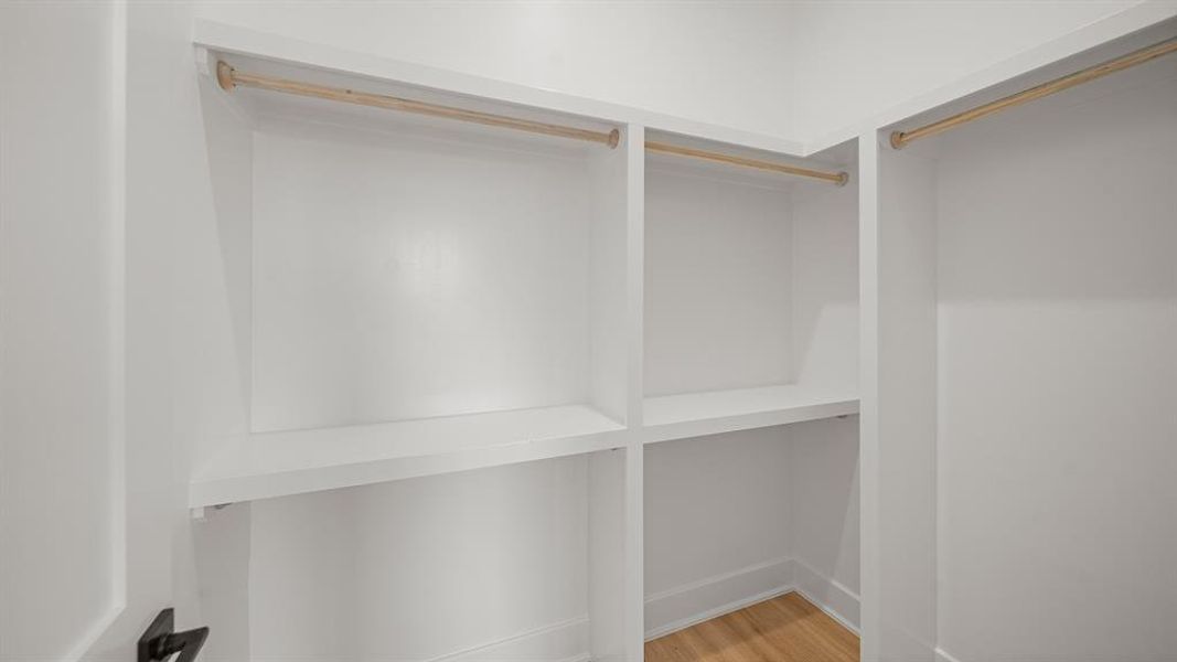 Spacious walk-in closet for the primary suite.