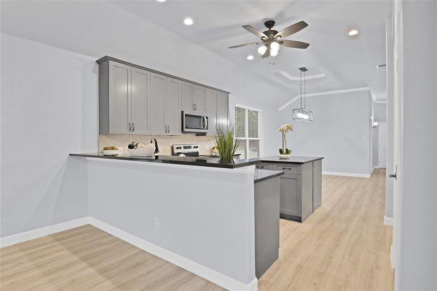 Kitchen featuring a breakfast bar that overlooks the living room.