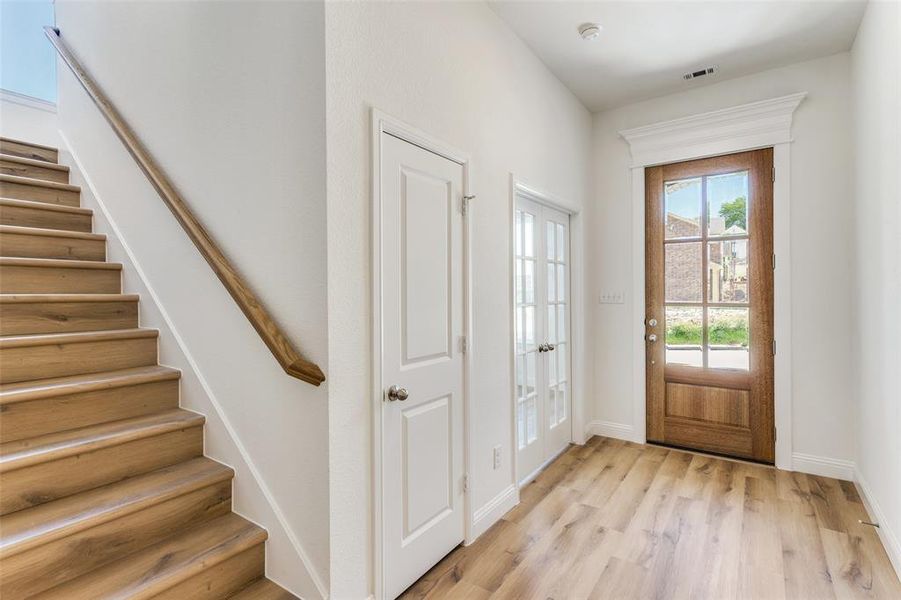 Foyer with light hardwood / wood-style floors