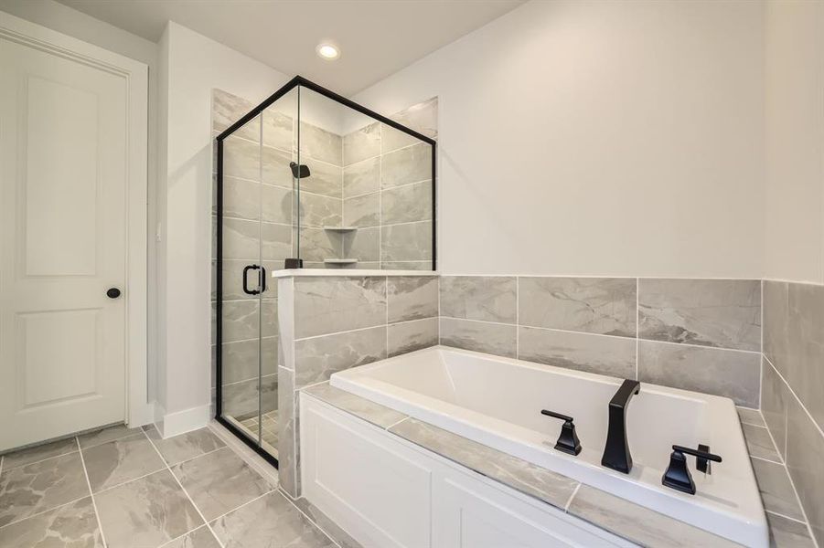 Full bath with a garden tub, a stall shower, marble look tile flooring, and recessed lighting Full bath with a garden tub, a stall shower, marble look tile flooring, and recessed lighting