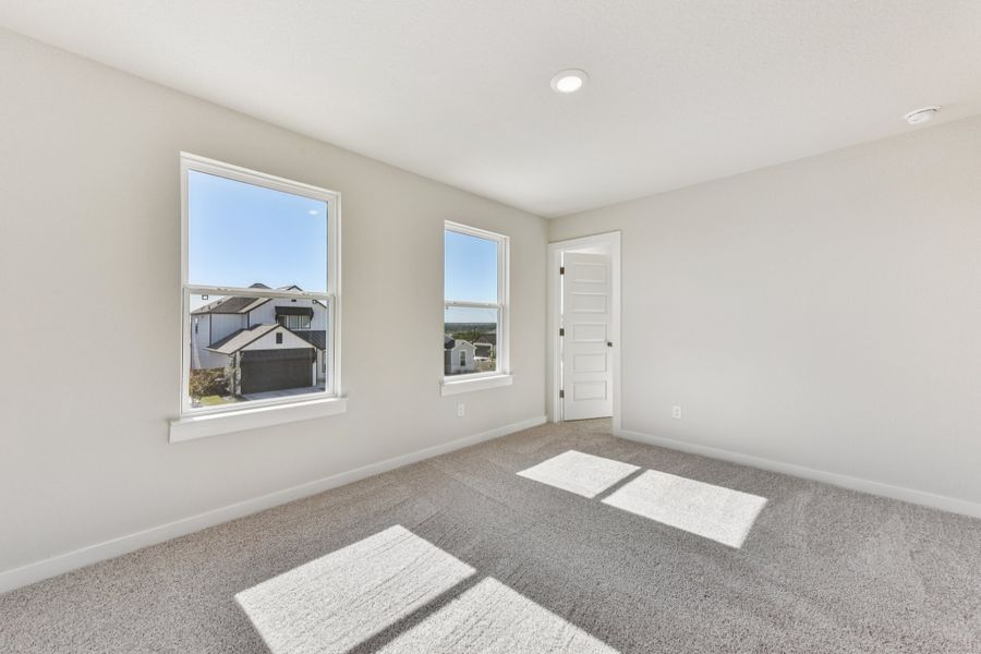A room with a window and a rug.