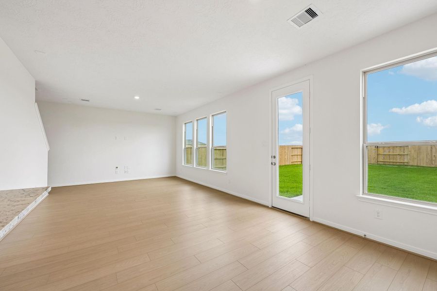 Create lasting memories around the table with family and friends in this inviting dining room! It showcases high ceilings, large window, access door to the back patio and yard, vinyl plank flooring, and recessed lighting for a warm and welcoming atmosphere. Create lasting memories around the table with family and friends in this inviting dining room! It showcases high ceilings, large window, access door to the back patio and yard, vinyl plank flooring, and recessed lighting for a warm and welcoming atmosphere.