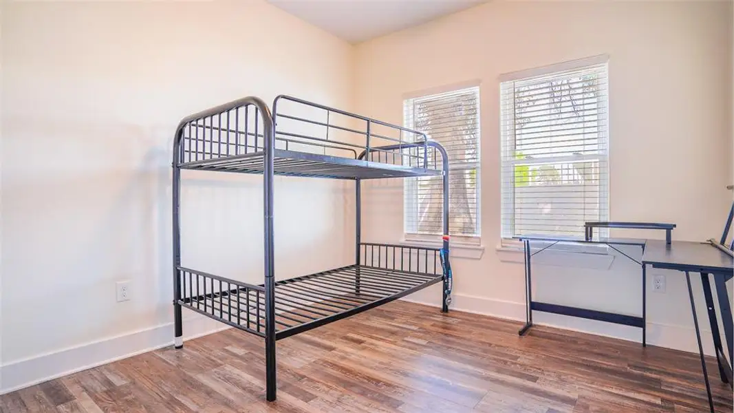 Bedroom with wood finished floors and baseboards Bedroom with wood finished floors and baseboards