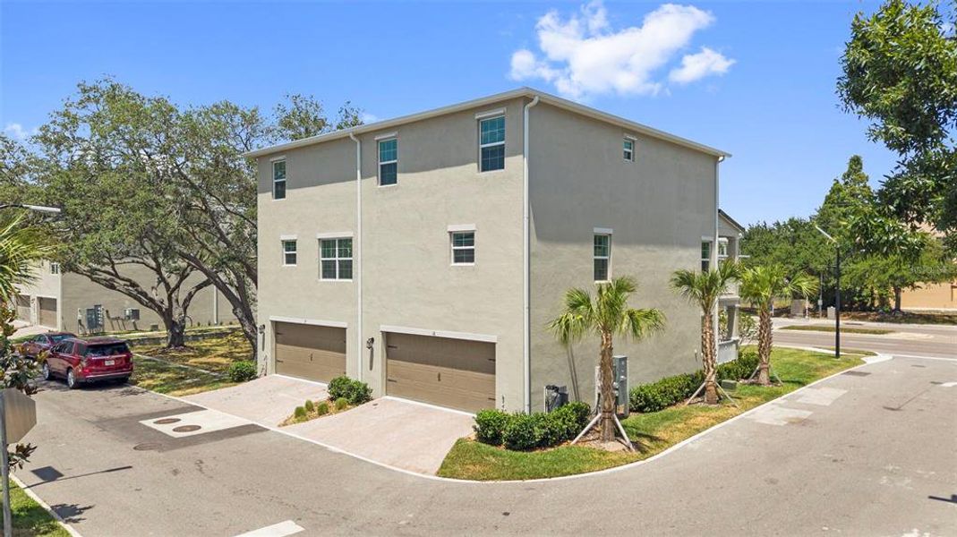 Front exterior of a new home in Townes at Manhattan Crossing, Tampa, FL, highlighting curb appeal (Image 27).