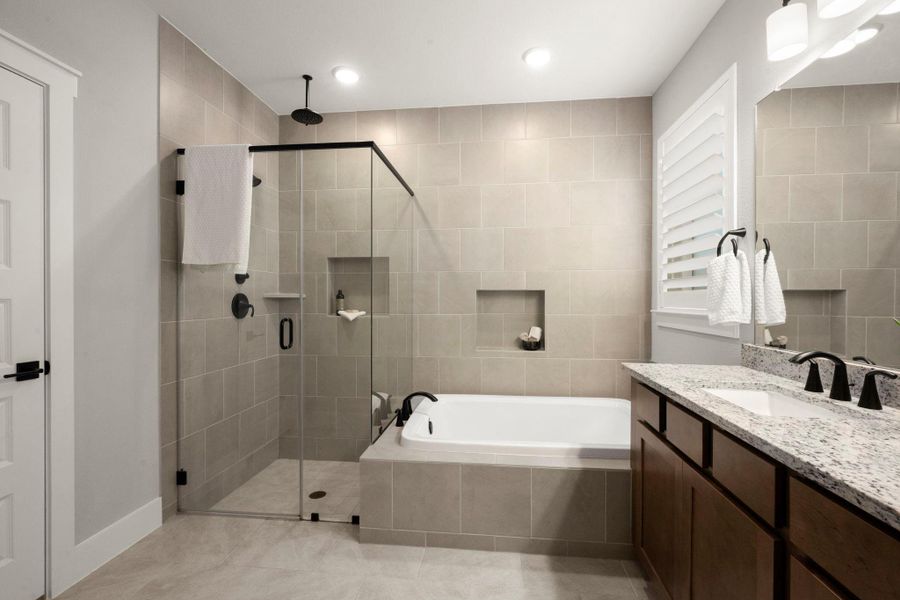 Floor-to-ceiling tile defines the walk-in shower and soaking tub. Floor-to-ceiling tile defines the walk-in shower and soaking tub.