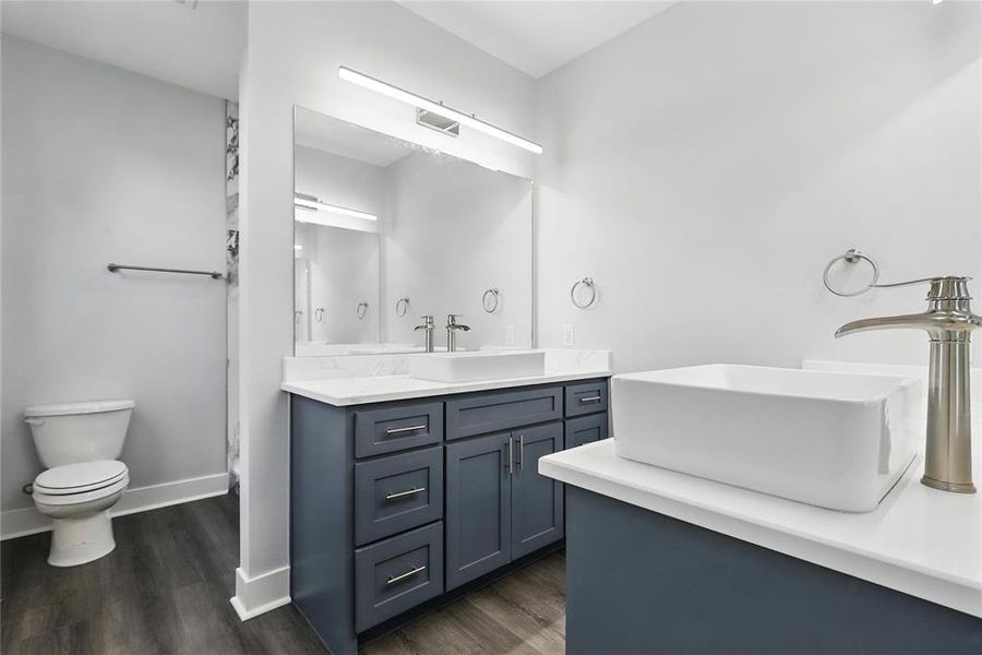 Full bath with vanity and dark wood finished floors