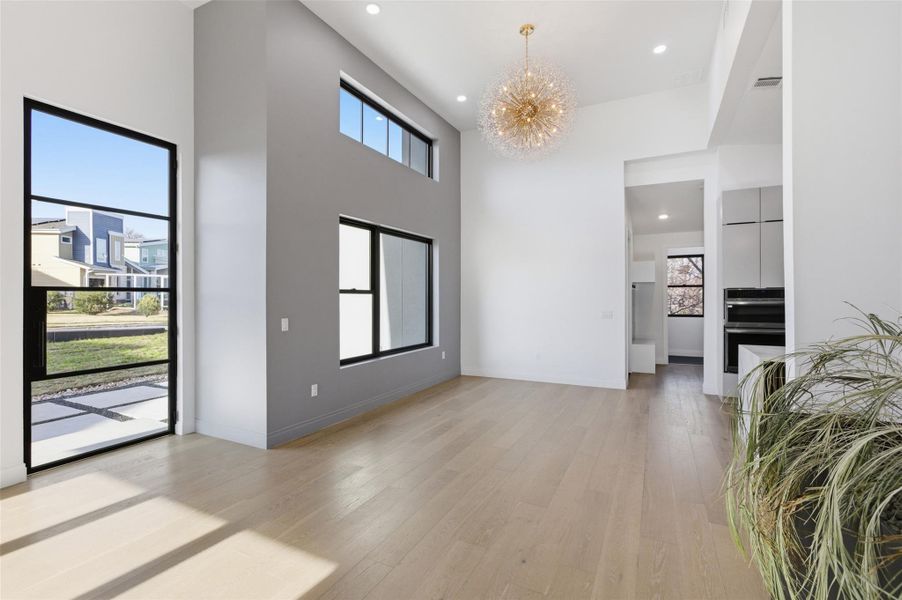 View of entry and dinning area with a statement piece chandelier.