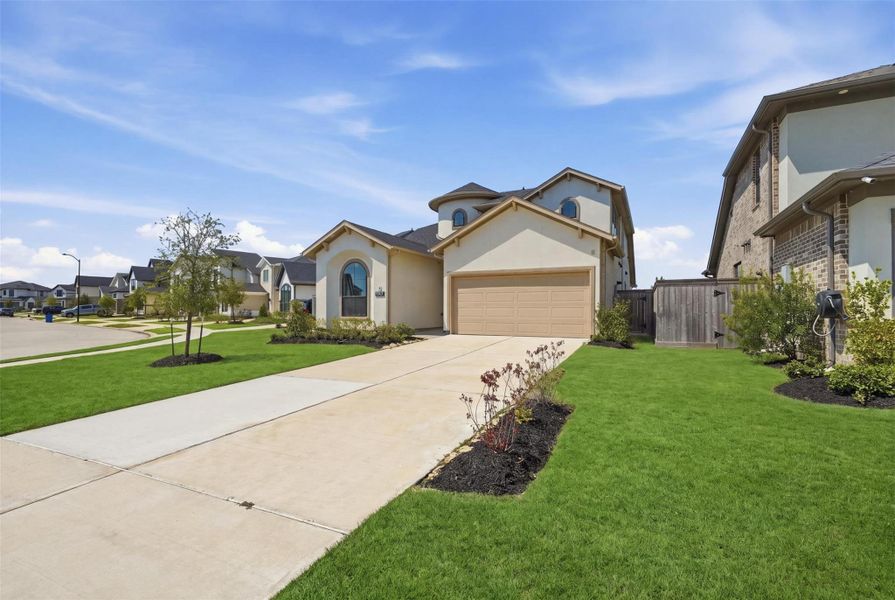 Front exterior of a new home in Bridgeland 45', 50', 70', Cypress, TX, highlighting curb appeal (Image 2). Front exterior of a new home in Bridgeland 45', 50', 70', Cypress, TX, highlighting curb appeal (Image 2).