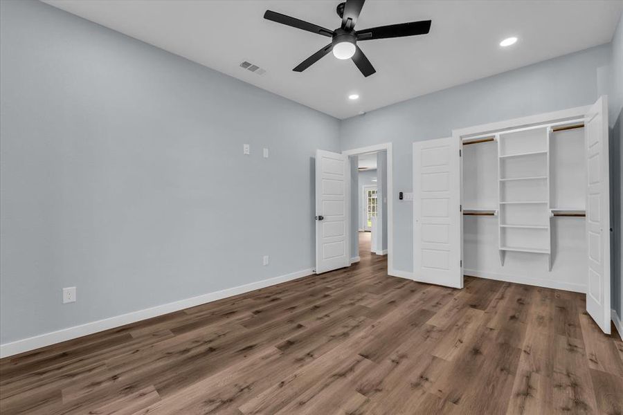 Unfurnished bedroom featuring dark wood-style flooring, ceiling fan, recessed lighting, and a closet Unfurnished bedroom featuring dark wood-style flooring, ceiling fan, recessed lighting, and a closet