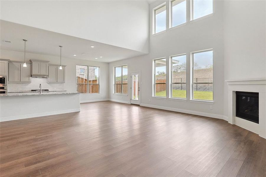 Unfurnished living room with sink and wood-type flooring