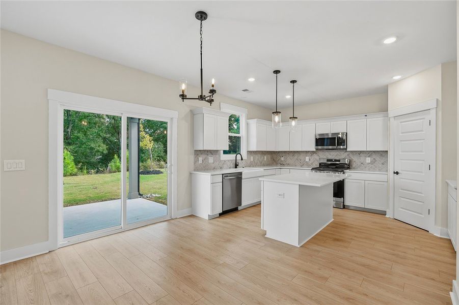 Sliding glass doors open from the kitchen to a cov