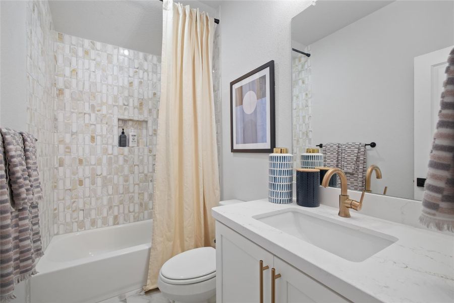 Bathroom featuring shower / bath combination with curtain and vanity