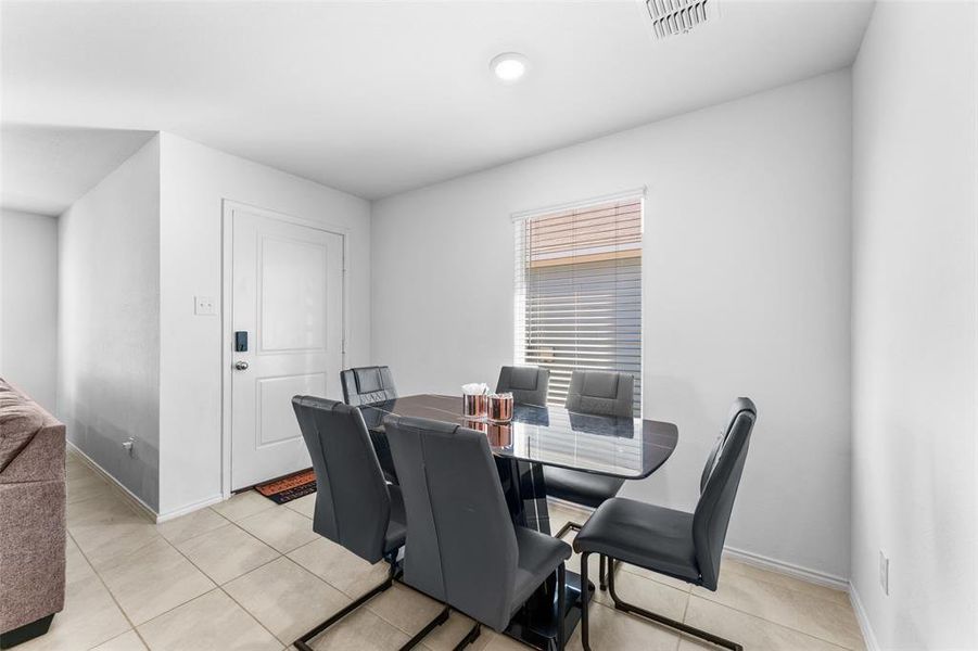 Dining room with light tile patterned floors Dining room with light tile patterned floors
