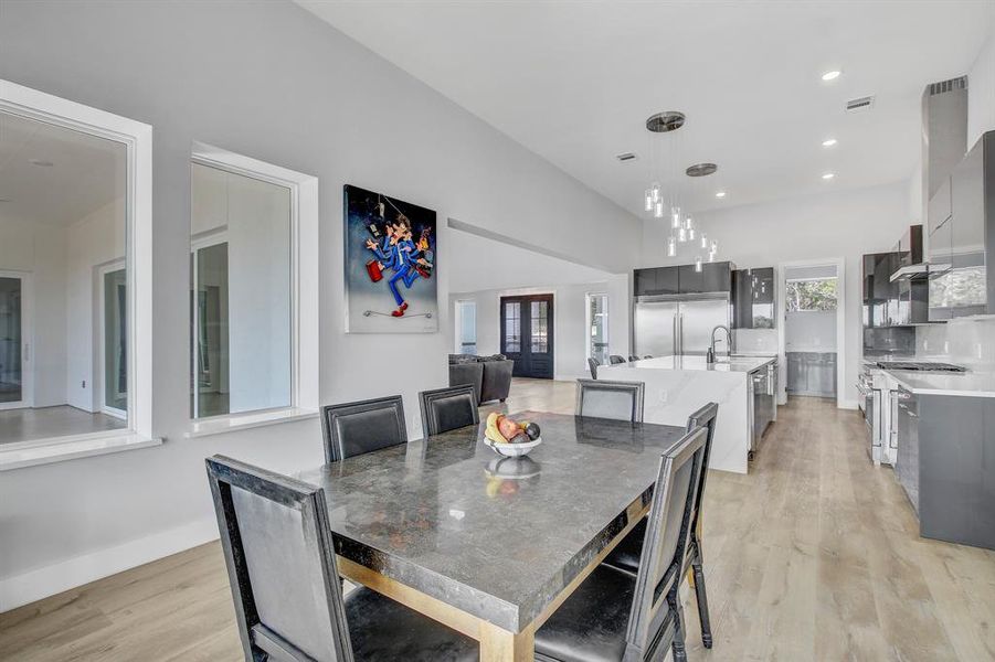 Dining area featuring light wood-type flooring and recessed lighting