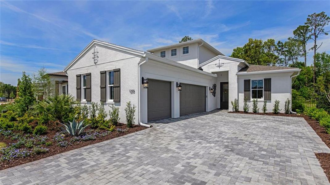 Front exterior of a new home in Cresswind DeLand, Deland, FL, highlighting curb appeal (Image 2). Front exterior of a new home in Cresswind DeLand, Deland, FL, highlighting curb appeal (Image 2).