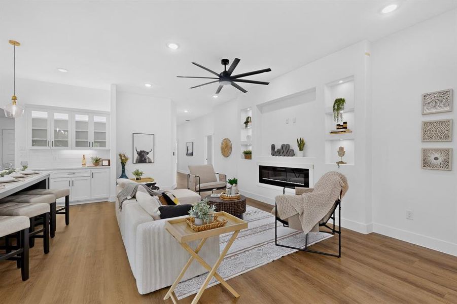 Open-concept living space featuring wood-finish flooring, recessed lighting, and a modern ceiling fan