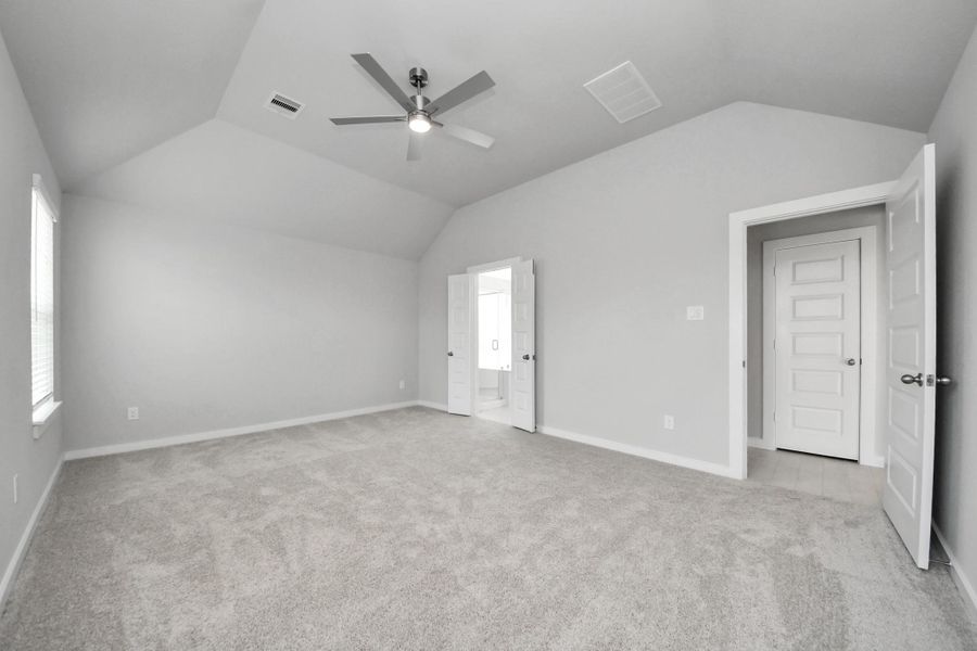 Come and unwind after a long day in this magnificent primary suite! This spacious room features plush carpet, warm paint, high ceilings and large windows with privacy blinds. Sample photo of completed home with similar floor plan. Actual colors and selections may vary.
