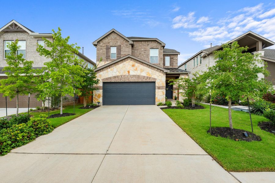 A handsome stone and brick facade with a neatly paved driveway offers inviting curb appeal. A handsome stone and brick facade with a neatly paved driveway offers inviting curb appeal.