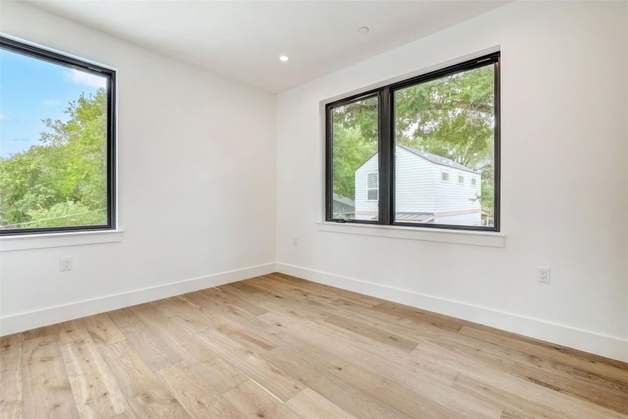 Unfurnished room featuring light wood-type flooring and recessed lighting Unfurnished room featuring light wood-type flooring and recessed lighting