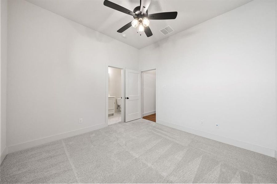 Empty room featuring carpet floors and ceiling fan