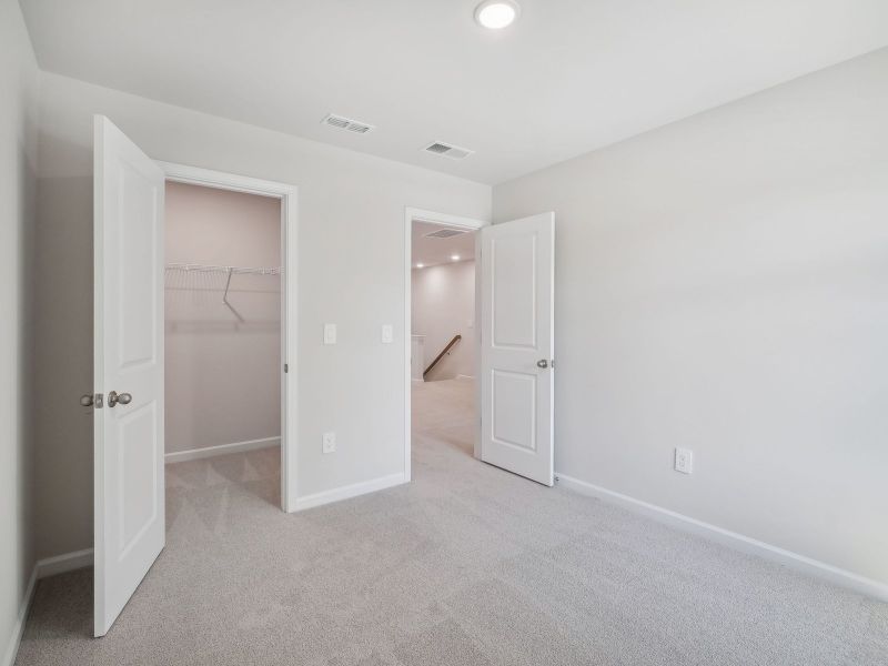 Two secondary bedrooms are ideally situated away from the primary suite.