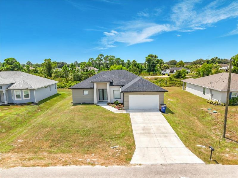 Front exterior of a new home in , Lehigh Acres, FL, highlighting curb appeal (Image 21). Front exterior of a new home in , Lehigh Acres, FL, highlighting curb appeal (Image 21).