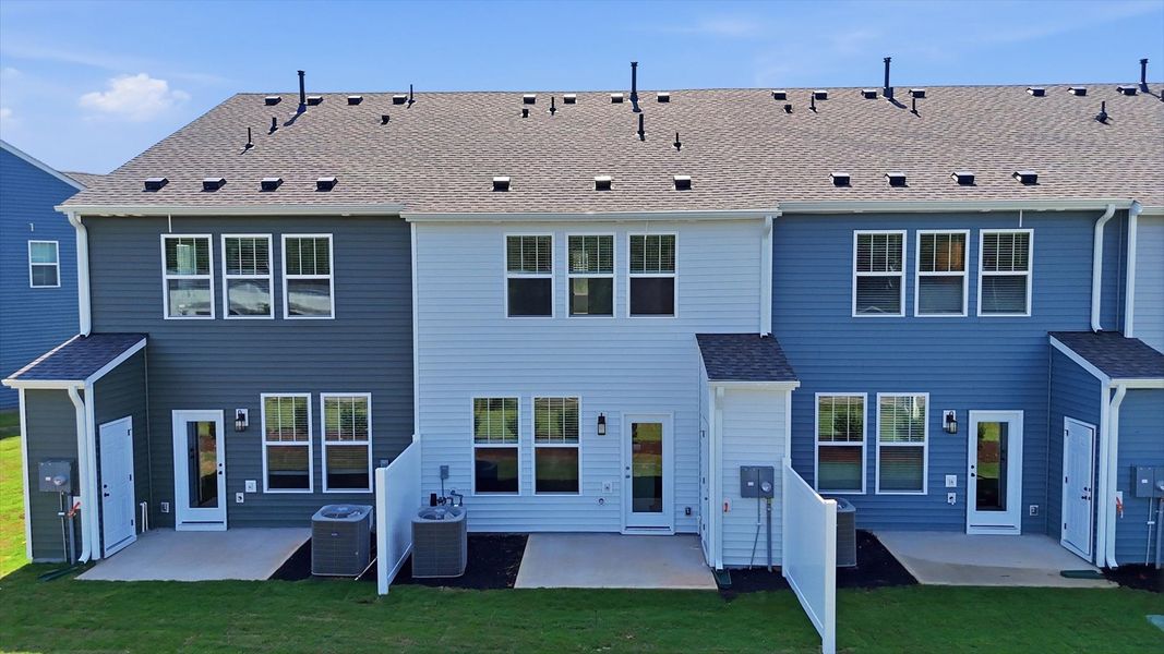 Refined rear exterior with a private backyard and patio for dining, relaxing, or entertaining by DRB Homes