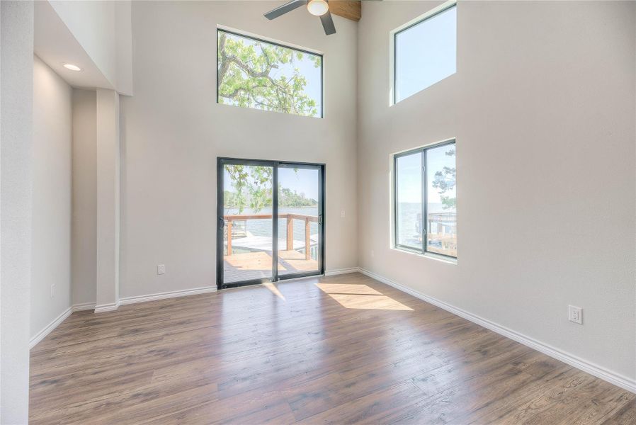 MASTER BEDROOM, HIGH CEILINGS WITH LOTS OF WINDOWS, WALK IN CLOSET AND A MILLION DOLLAR VIEW AND DOOR TO DECK