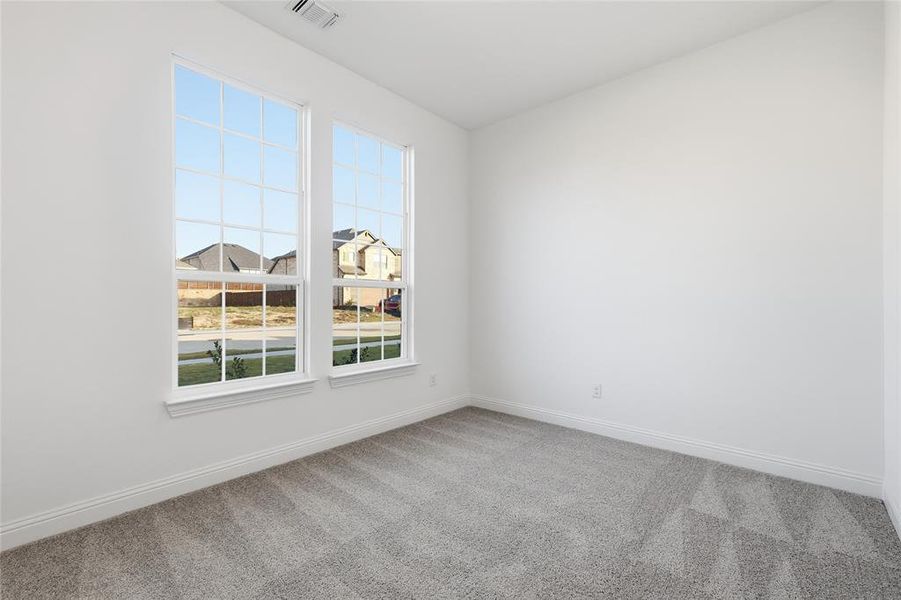 Empty room with baseboards and carpet