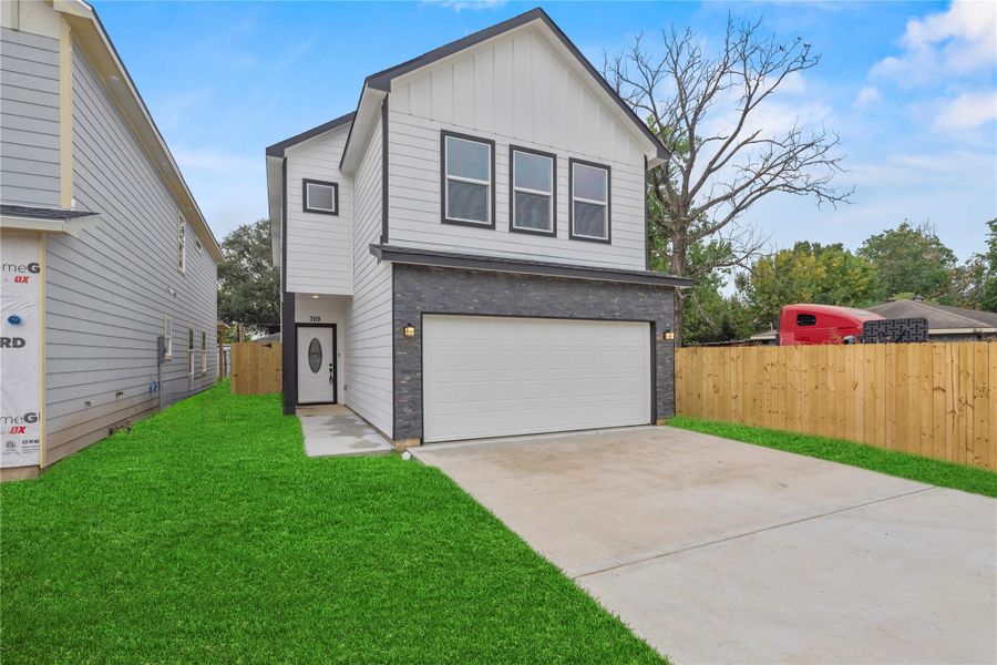 This modern two-story home features a clean exterior design with sleek black and white contrast and a covered front entry. The attached two-car garage offers ample parking and storage space. This modern two-story home features a clean exterior design with sleek black and white contrast and a covered front entry. The attached two-car garage offers ample parking and storage space.