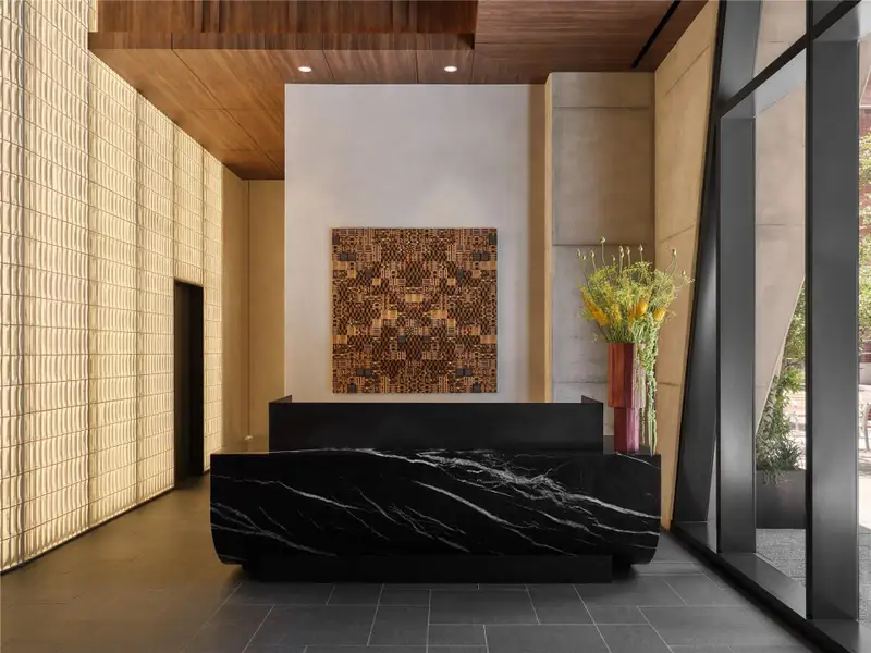 Dramatic architectural textures and rich wood ceilings frame this secure entrance foyer. Dramatic architectural textures and rich wood ceilings frame this secure entrance foyer.
