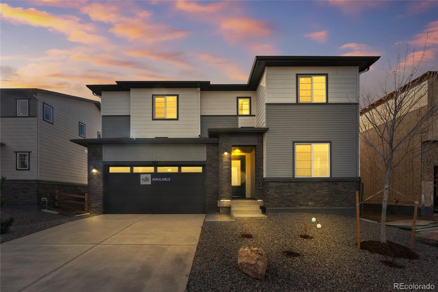 Front exterior of a new home in Harvest Crossing, Aurora, CO, highlighting curb appeal (Image 1).
