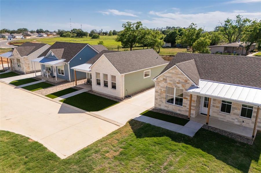 Row of properties featuring diverse exterior finishes including stone veneer and siding