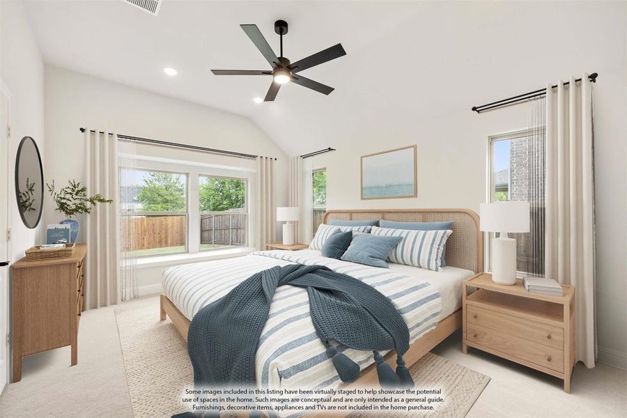Bedroom with vaulted ceiling, ceiling fan, large windows, and wood-framed bed with blue striped bedding