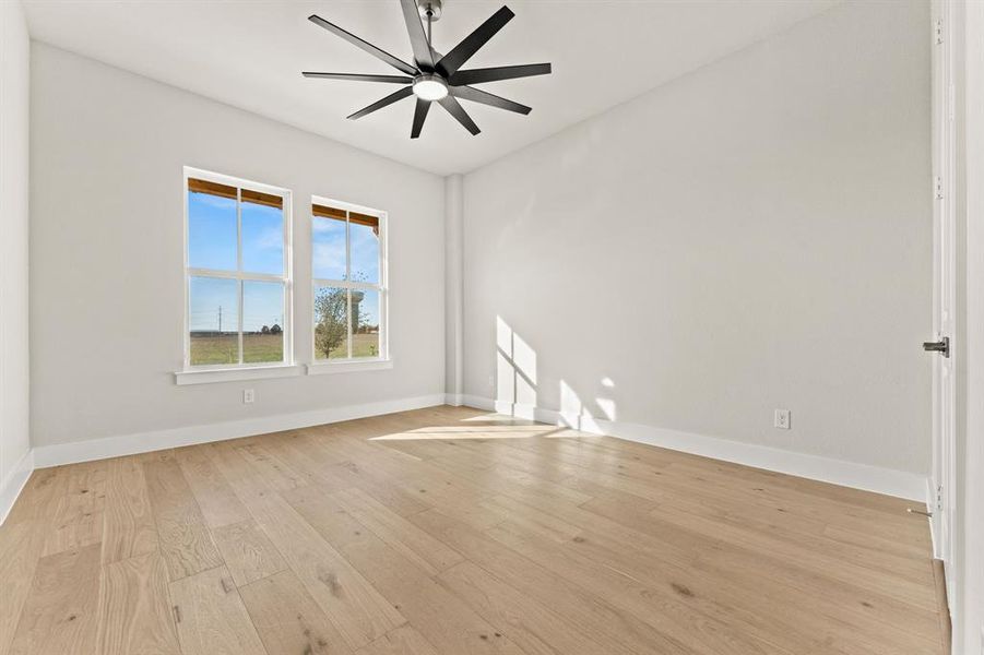 Spare room featuring light hardwood / wood-style floors and ceiling fan