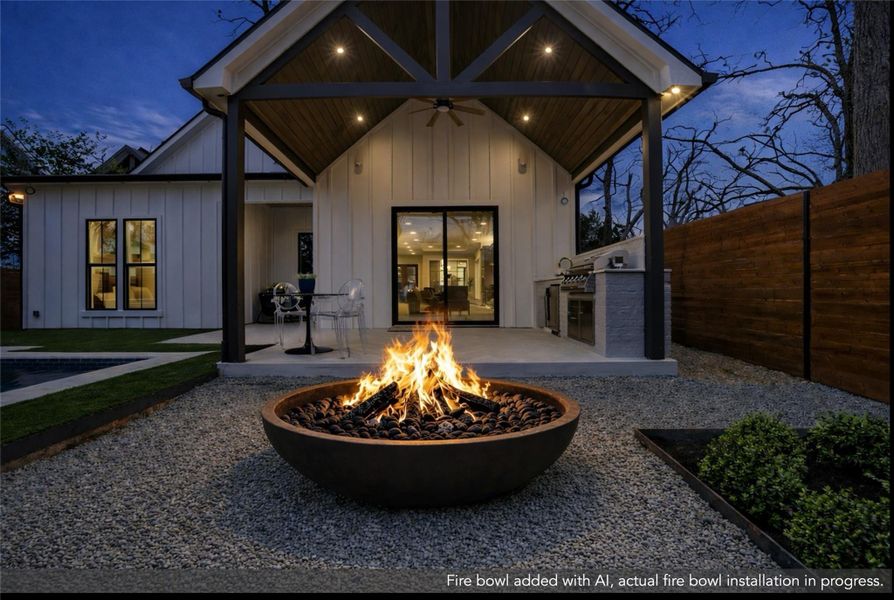 Back of house with area for grilling, a patio area, ceiling fan, board and batten siding, and an outdoor fire pit