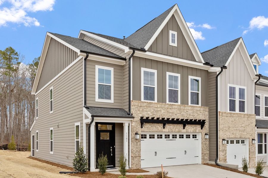 Front exterior of a new home in Ovation at Sweetbrier, Durham, NC, highlighting curb appeal (Image 2). Front exterior of a new home in Ovation at Sweetbrier, Durham, NC, highlighting curb appeal (Image 2).
