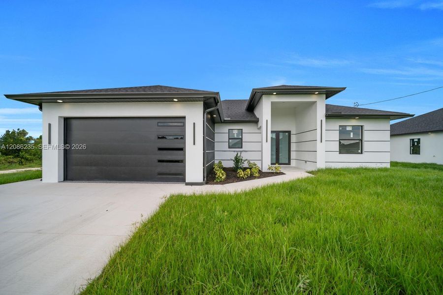 Front exterior of a new home in , Lehigh Acres, FL, highlighting curb appeal (Image 17).
