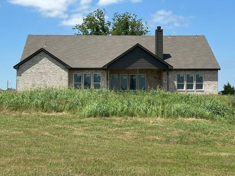 Brick exterior with a gabled roof and dark shingle accents