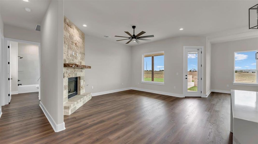 Rich wood floors and a stone fireplace define this open living area. Rich wood floors and a stone fireplace define this open living area.