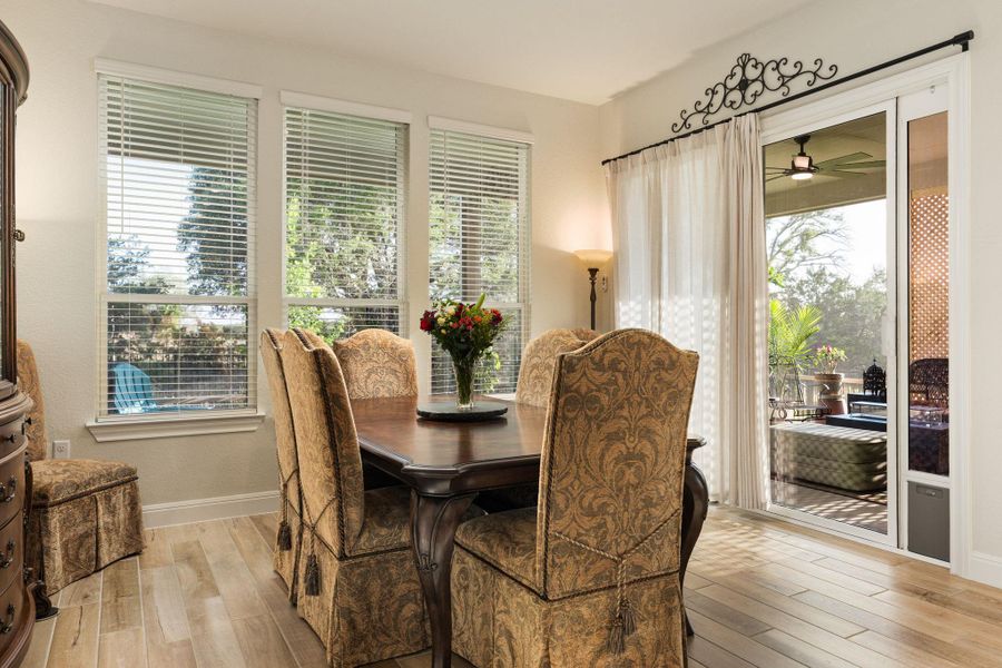 The dining area is connected to the kitchen and overlooks the backyard/patio. The dining area is connected to the kitchen and overlooks the backyard/patio.