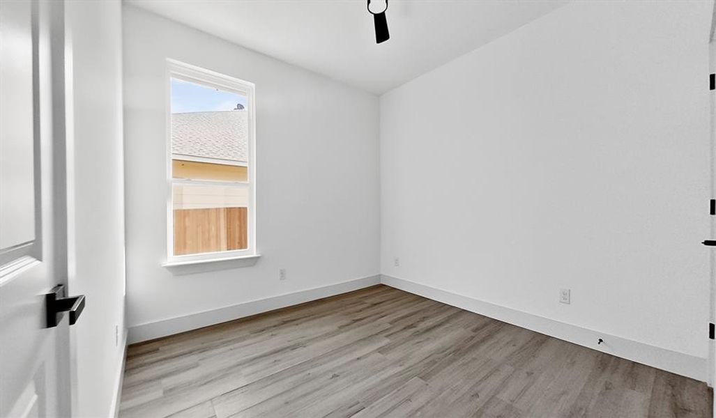 Unfurnished room with light wood-style floors and a ceiling fan