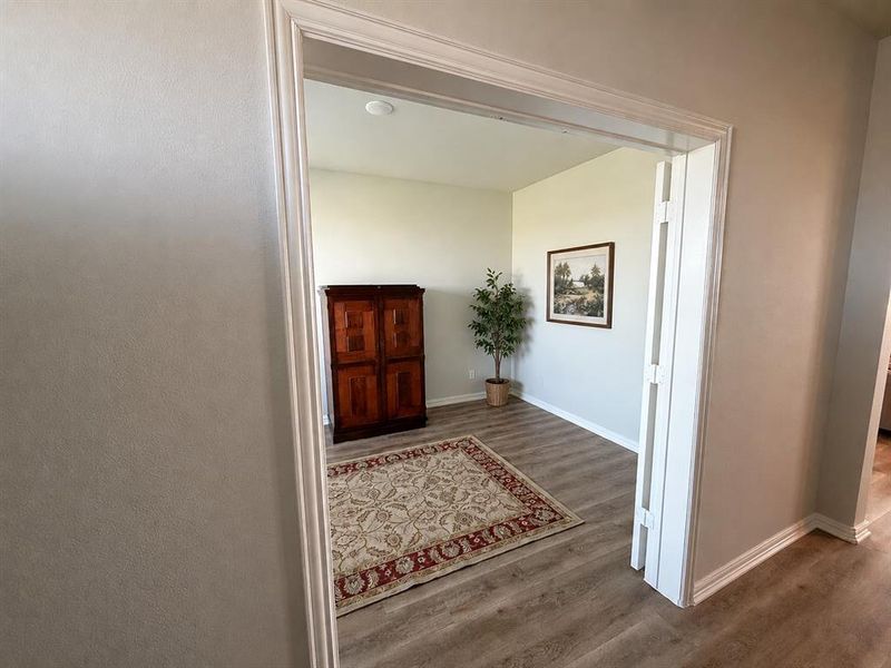 Room entrance featuring light-toned wood-finish flooring and neutral wall tones