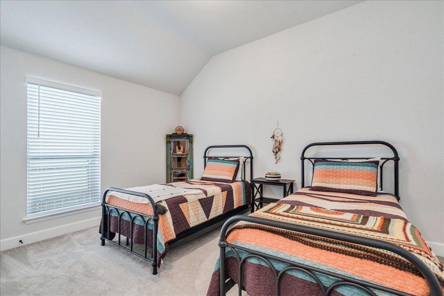 Bedroom featuring carpet floors and lofted ceiling